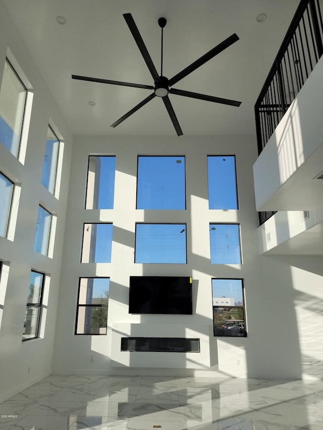 interior space featuring light tile floors and ceiling fan