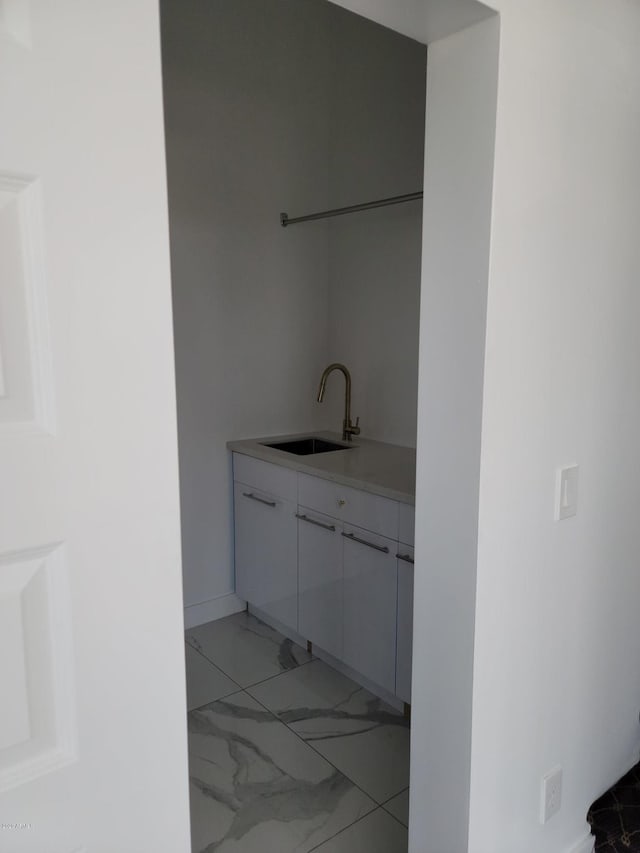 bathroom featuring tile flooring and sink