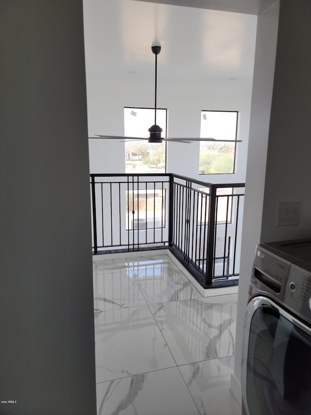 clothes washing area with light tile flooring and washer / dryer