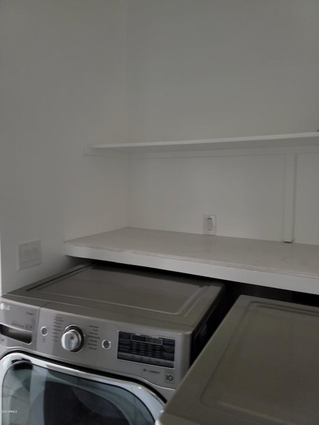 clothes washing area featuring washer and dryer