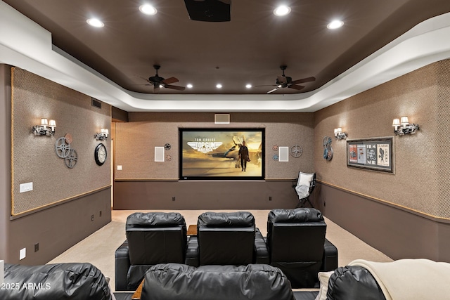 carpeted home theater featuring a ceiling fan, recessed lighting, and a raised ceiling