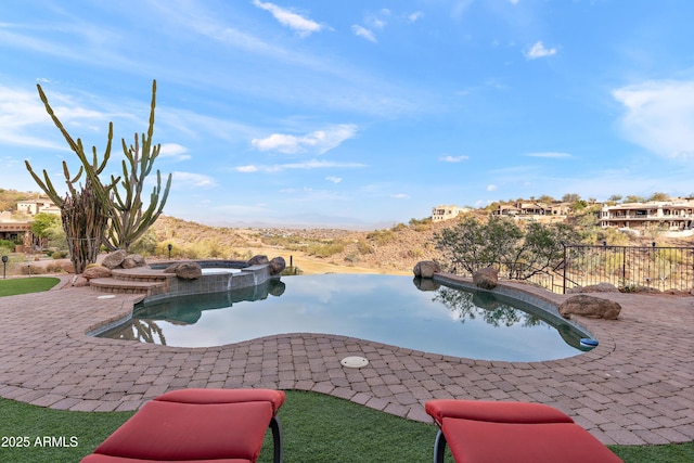 outdoor pool featuring an in ground hot tub and a patio area