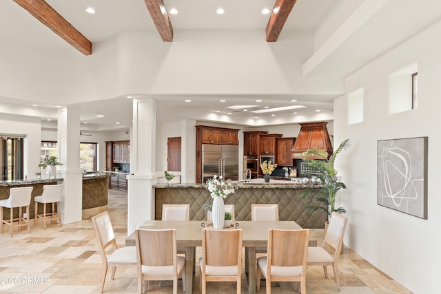 dining room featuring decorative columns, stone finish flooring, beam ceiling, and recessed lighting