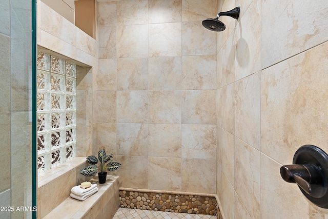 bathroom with a tile shower