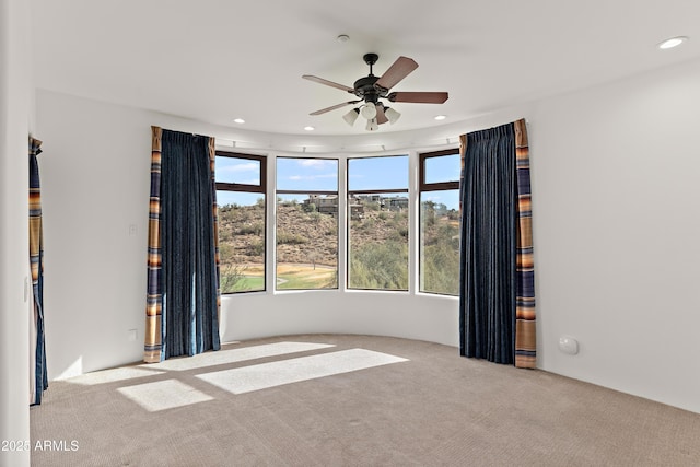 carpeted empty room featuring a ceiling fan and recessed lighting