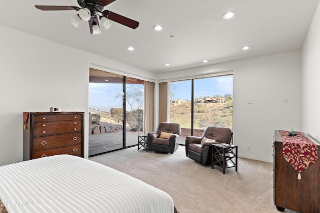 bedroom with recessed lighting, access to outside, and light colored carpet