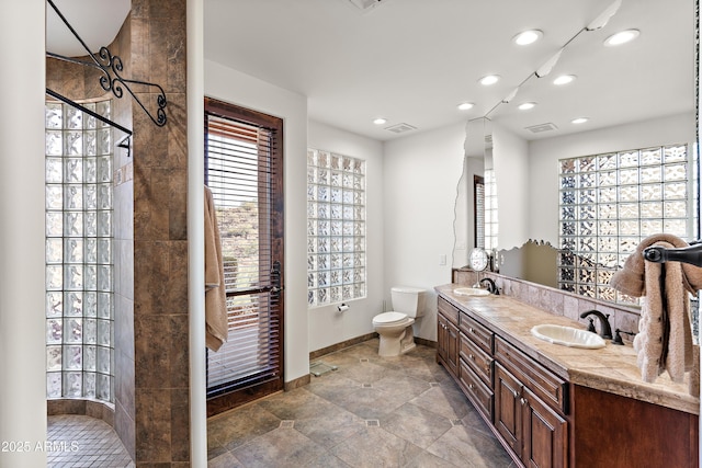 full bath featuring visible vents, a sink, and toilet