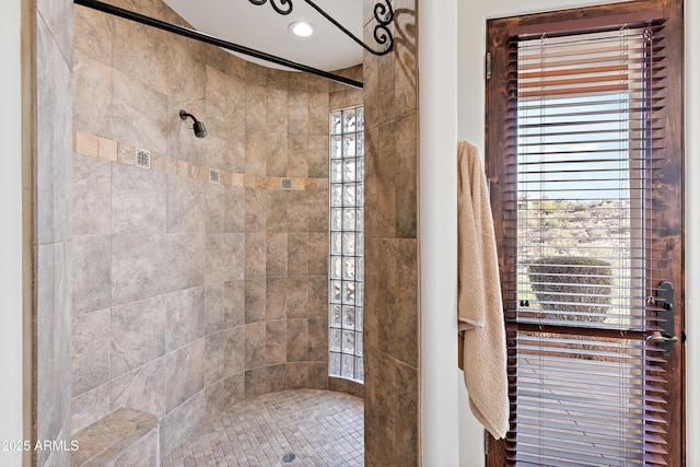 bathroom with a tile shower and recessed lighting