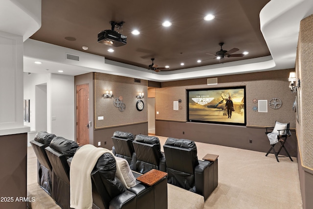 carpeted cinema with ceiling fan, a raised ceiling, visible vents, and recessed lighting