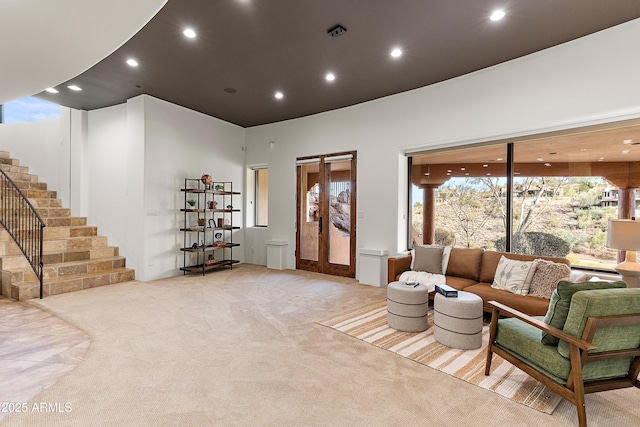 living area featuring carpet floors, stairway, french doors, and recessed lighting