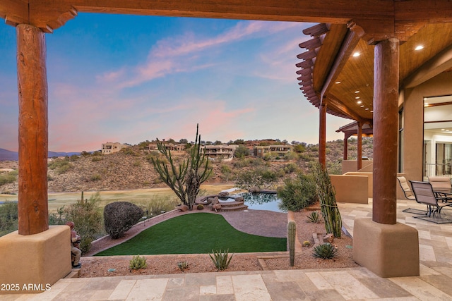 view of patio terrace at dusk