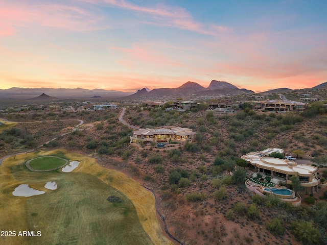 aerial view at dusk featuring a mountain view