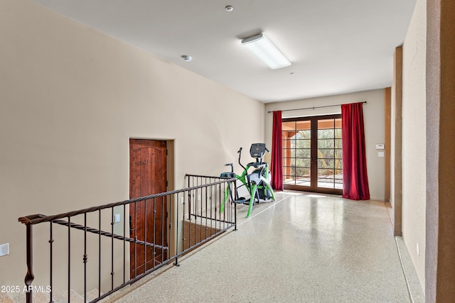 corridor with french doors and speckled floor