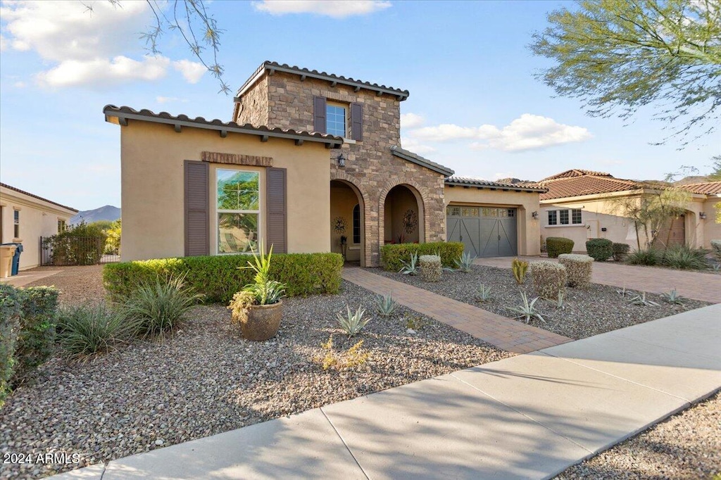 mediterranean / spanish-style house with a garage