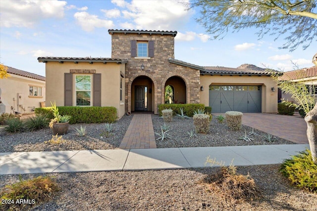 mediterranean / spanish house featuring a garage