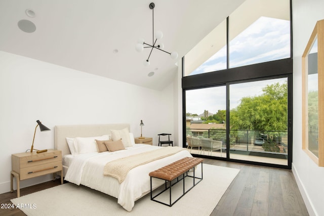 bedroom featuring high vaulted ceiling, hardwood / wood-style floors, access to outside, and a chandelier