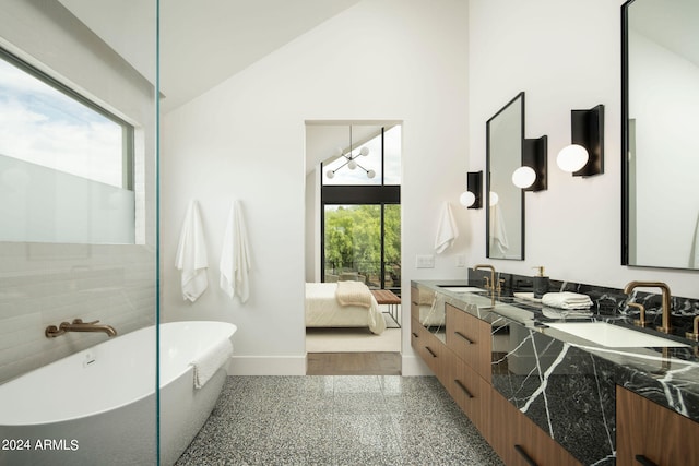 bathroom featuring high vaulted ceiling, dual bowl vanity, hardwood / wood-style flooring, and a bathtub