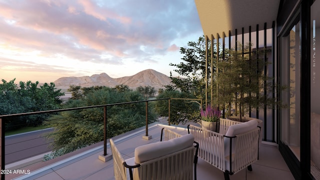 balcony at dusk featuring an outdoor hangout area and a mountain view