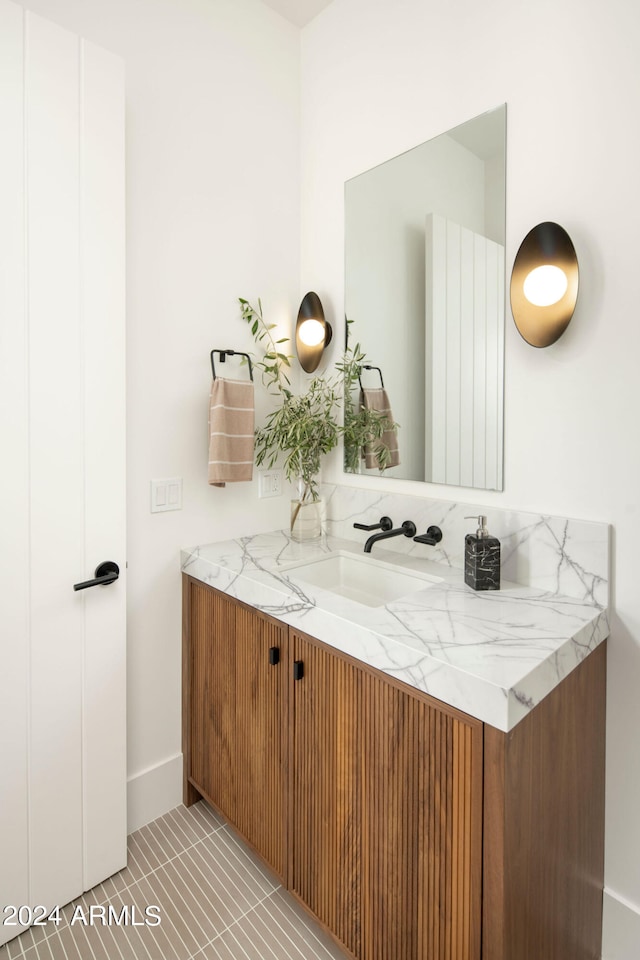 bathroom featuring tile flooring and vanity