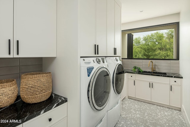 laundry room featuring sink, separate washer and dryer, and cabinets