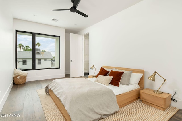 bedroom with hardwood / wood-style floors and ceiling fan