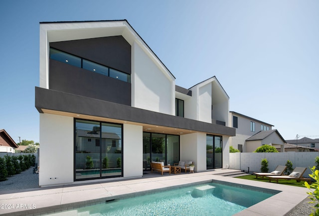 exterior space with a patio area and a fenced in pool