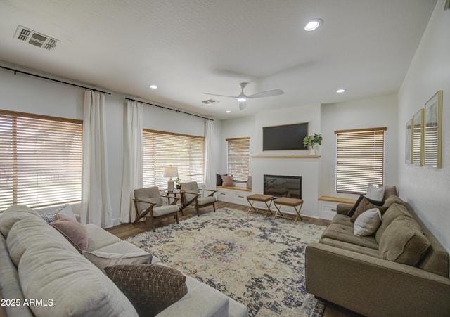 4609 E Ironhorse Rd, Gilbert, AZ 85297 - living area featuring a ceiling fan, recessed lighting, a glass covered fireplace, and wood finished floors