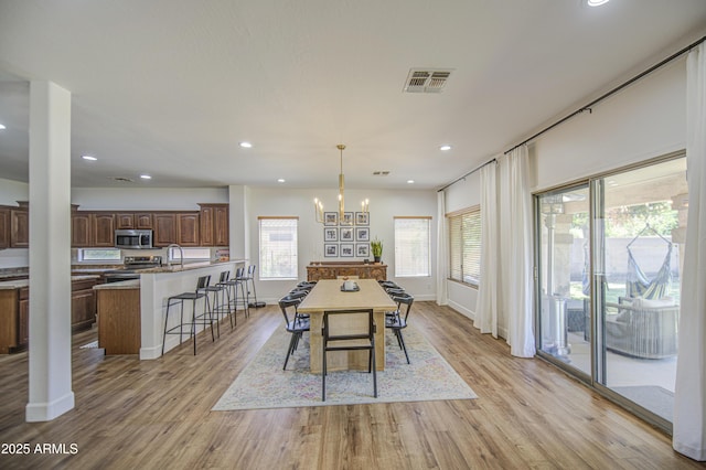 4609 E Ironhorse Rd, Gilbert, AZ 85297 - dining space featuring light wood finished floors, recessed lighting, baseboards, and a chandelier