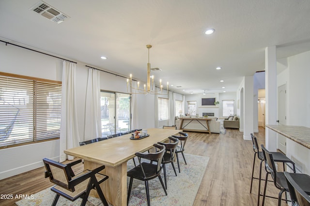 4609 E Ironhorse Rd, Gilbert, AZ 85297 - dining area with a chandelier, light wood-style flooring, baseboards, and recessed lighting
