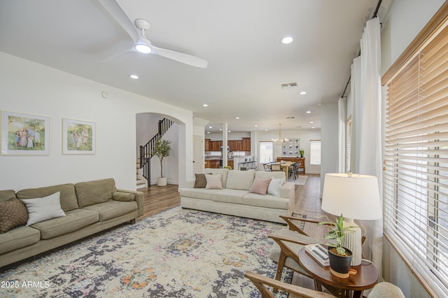4609 E Ironhorse Rd, Gilbert, AZ 85297 - living area featuring wood finished floors, ceiling fan, arched walkways, recessed lighting, and stairs