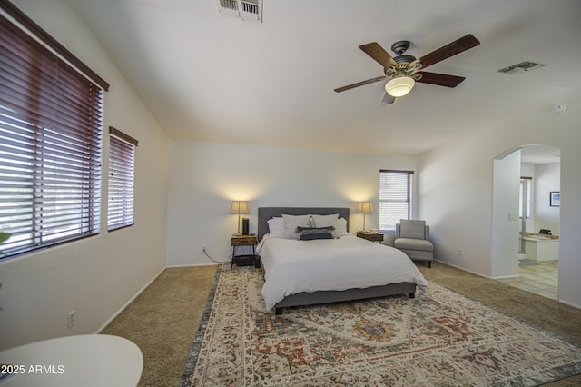 4609 E Ironhorse Rd, Gilbert, AZ 85297 - bedroom featuring arched walkways, carpet, ensuite bath, and a ceiling fan