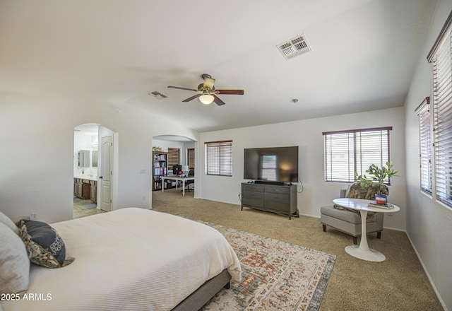 4609 E Ironhorse Rd, Gilbert, AZ 85297 - bedroom featuring arched walkways, light colored carpet, vaulted ceiling, a ceiling fan, and ensuite bath