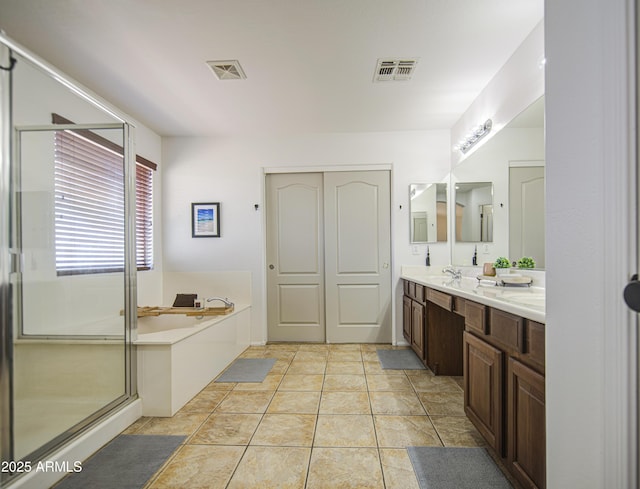 4609 E Ironhorse Rd, Gilbert, AZ 85297 - bathroom with double vanity, a bath, and a shower stall