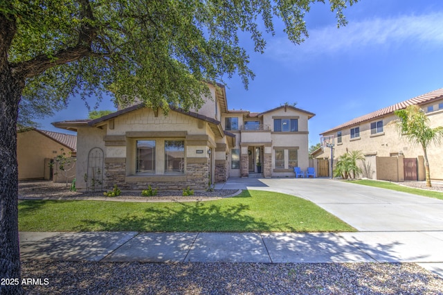 4609 E Ironhorse Rd, Gilbert, AZ 85297 - view of front of house featuring driveway, stone siding, and stucco siding
