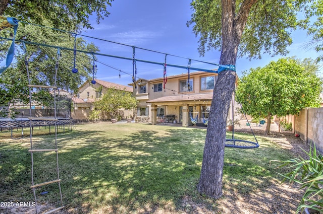 4609 E Ironhorse Rd, Gilbert, AZ 85297 - back of house featuring a trampoline, stucco siding, and a patio area