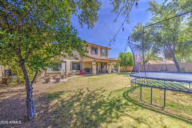 4609 E Ironhorse Rd, Gilbert, AZ 85297 - rear view of property featuring a trampoline, a patio area, a yard, and stucco siding