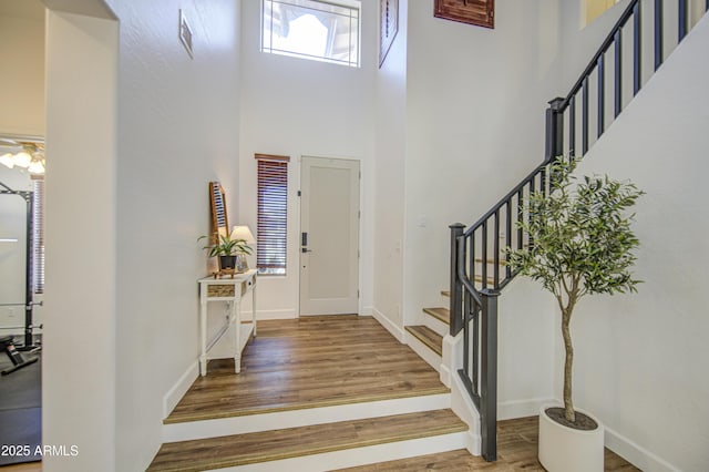 4609 E Ironhorse Rd, Gilbert, AZ 85297 - entryway with a towering ceiling, stairway, wood finished floors, and baseboards