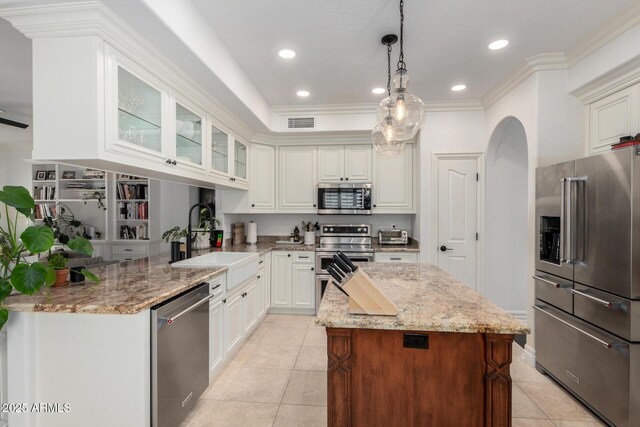 2026 E Cortez Dr, Gilbert, AZ 85234 - kitchen with stainless steel appliances, a sink, light tile patterned floors, light stone counters, and glass insert cabinets