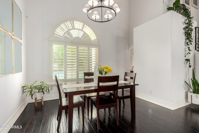 2026 E Cortez Dr, Gilbert, AZ 85234 - dining area featuring a chandelier, dark wood-style flooring, a high ceiling, and baseboards
