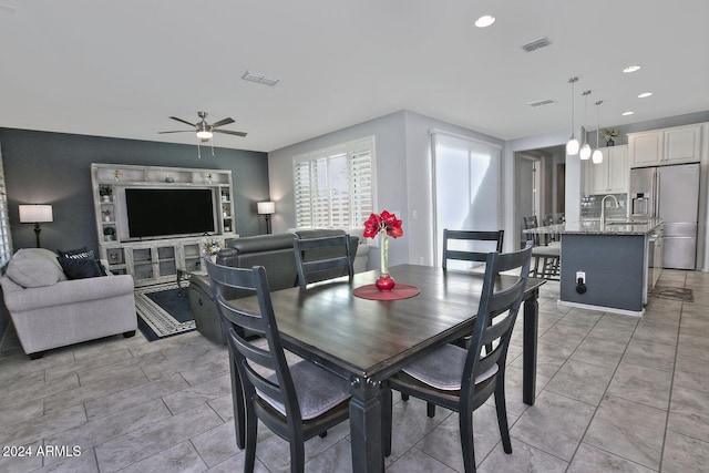 tiled dining room with ceiling fan