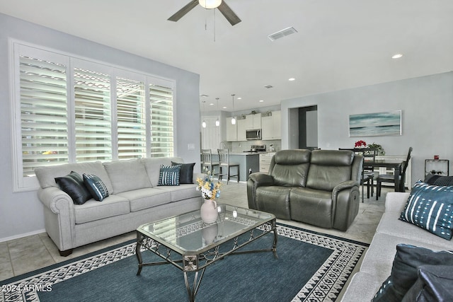 tiled living room with ceiling fan