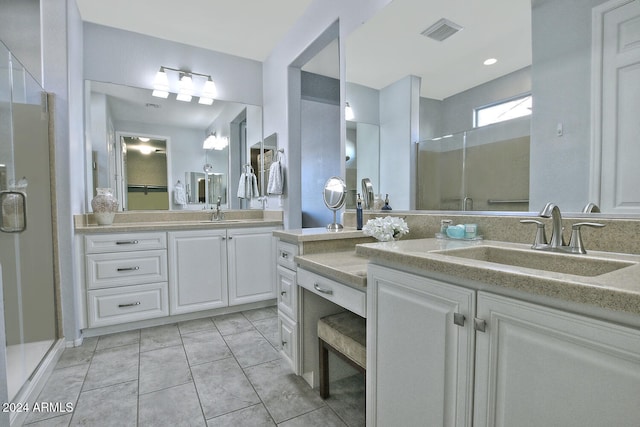 bathroom with vanity, tile patterned floors, and a shower with shower door