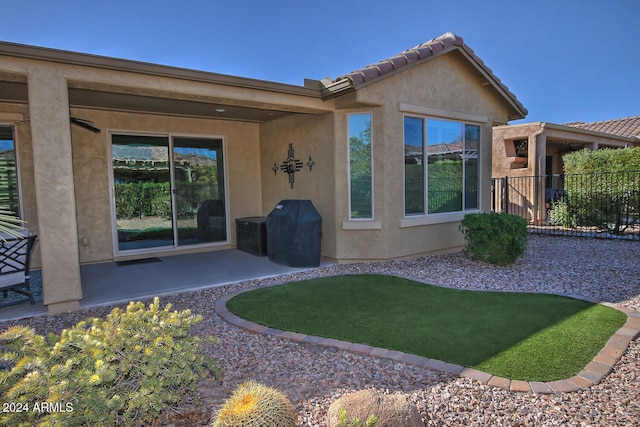 back of property featuring a patio area