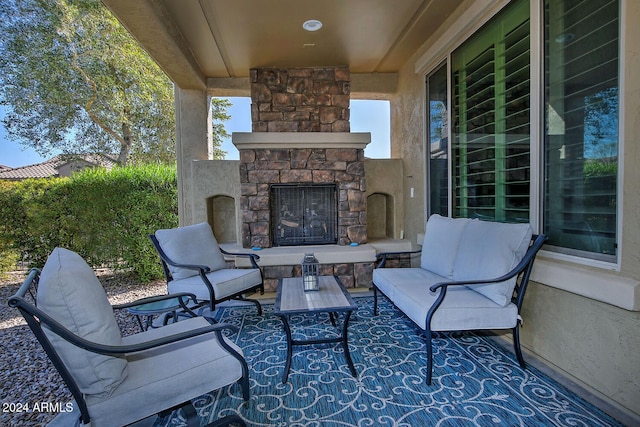 view of patio featuring an outdoor living space with a fireplace