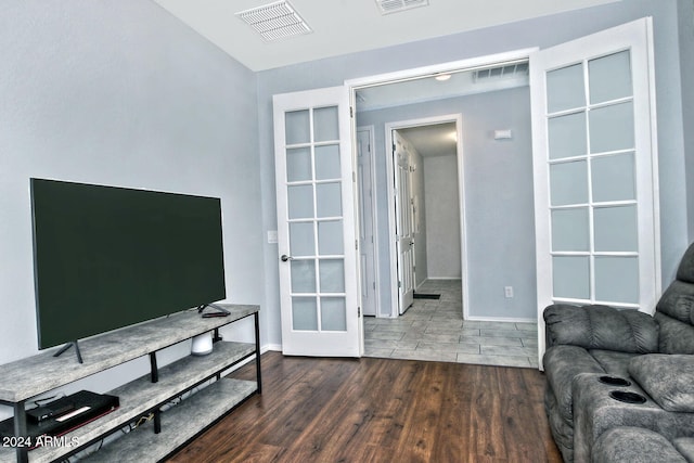 living room with french doors and dark wood-type flooring