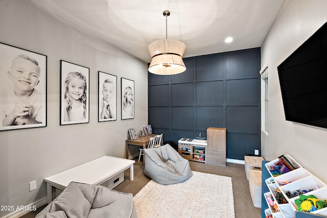 interior space featuring carpet floors, baseboards, a decorative wall, and recessed lighting