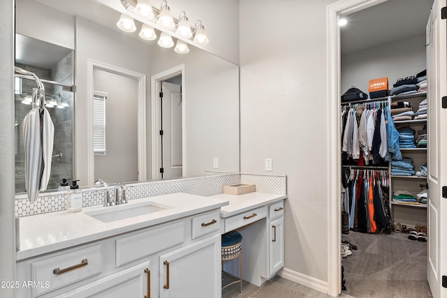 bathroom with vanity, tasteful backsplash, a stall shower, and a spacious closet