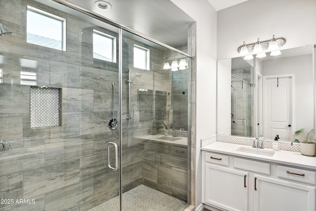 bathroom with vanity and a stall shower