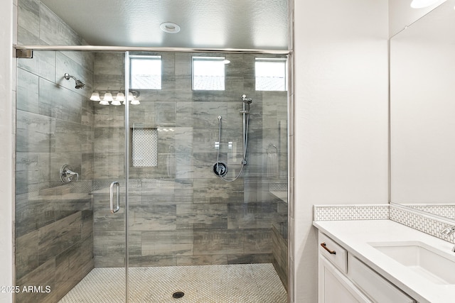 bathroom with vanity and a stall shower