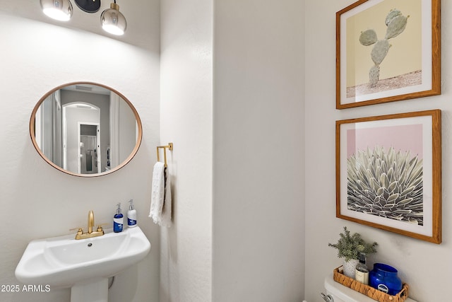 bathroom with toilet and a sink